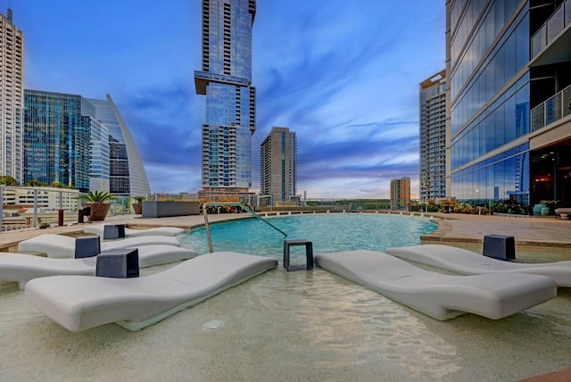501 W Ave Unit 2904, Austin, TX 78701 - pool at dusk featuring a city view and a community pool
