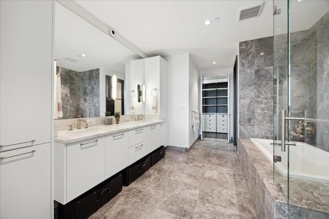501 W Ave Unit 2904, Austin, TX 78701 - bathroom featuring double vanity, a garden tub, a shower with shower door, recessed lighting, and marble finish flooring