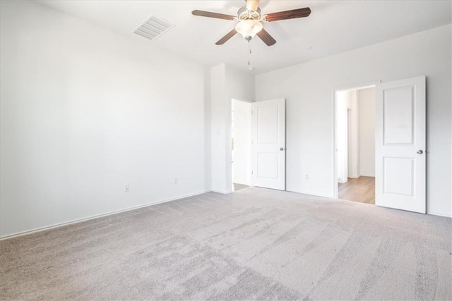 unfurnished bedroom with light colored carpet and ceiling fan