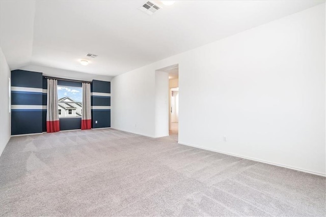 unfurnished room with carpet floors and vaulted ceiling