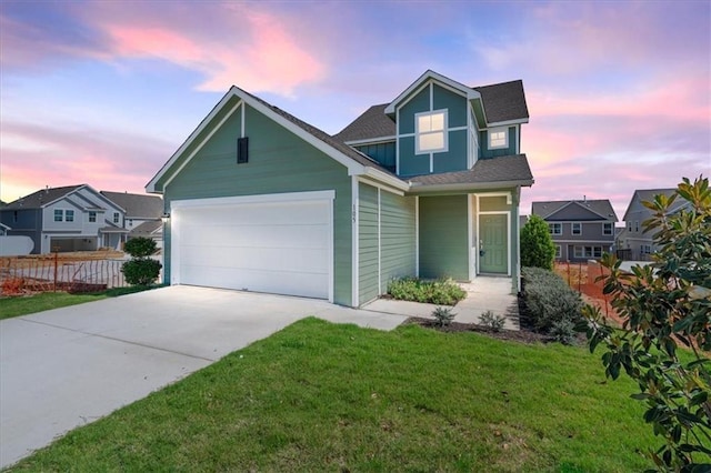 view of front of house featuring a yard and a garage