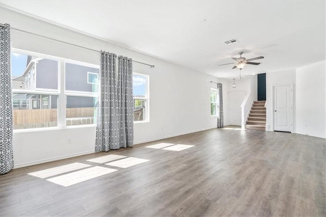 empty room with ceiling fan and hardwood / wood-style floors