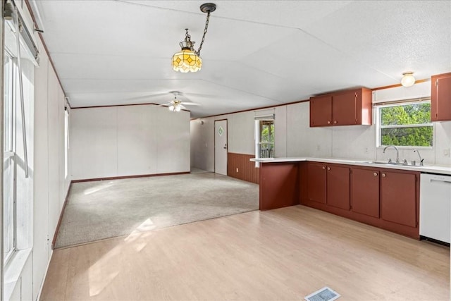 kitchen with sink, a healthy amount of sunlight, decorative light fixtures, and dishwasher