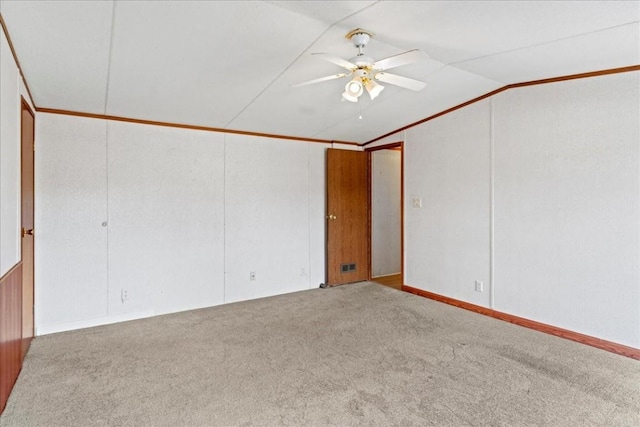 spare room featuring lofted ceiling, ceiling fan, and light colored carpet