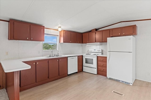 kitchen featuring white appliances, light hardwood / wood-style flooring, sink, lofted ceiling, and kitchen peninsula