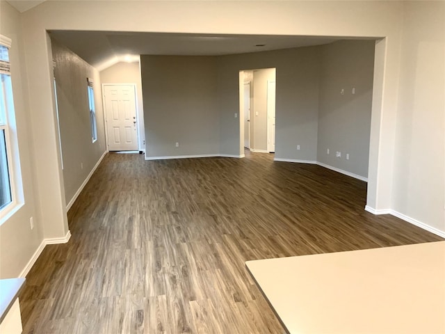 interior space with lofted ceiling and dark hardwood / wood-style floors