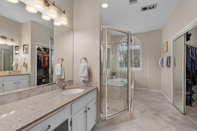 bathroom featuring an enclosed shower and vanity