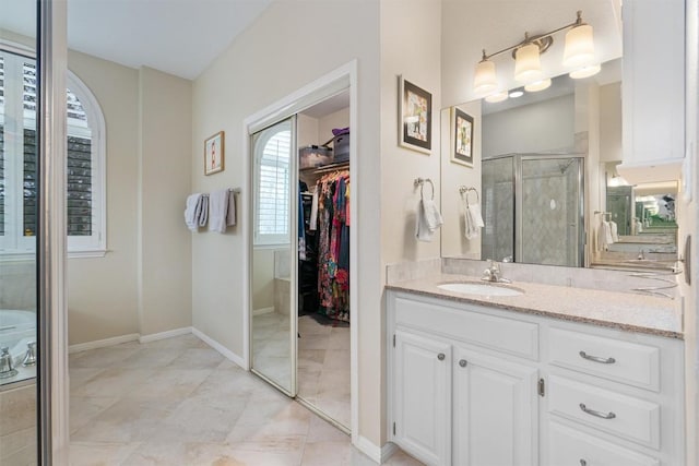 bathroom with tile patterned floors, vanity, and a shower with door