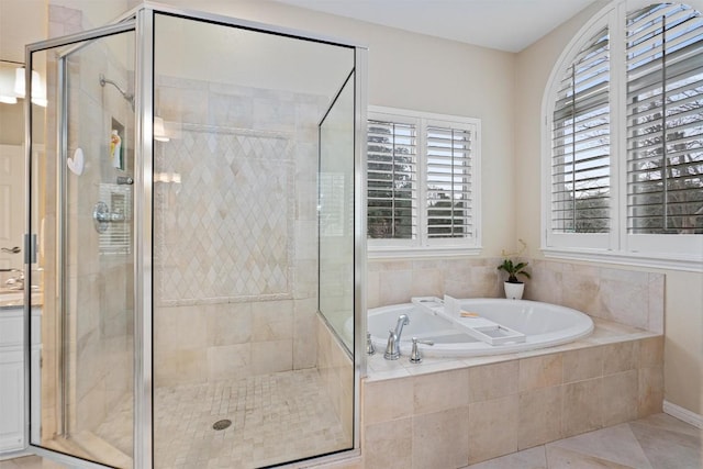 bathroom with separate shower and tub and tile patterned floors