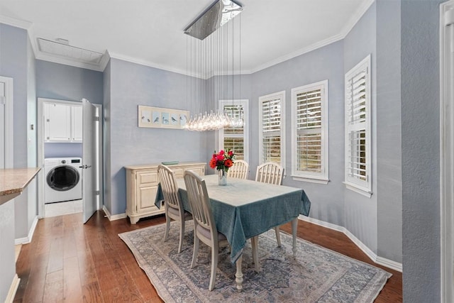 dining room with washer / dryer, dark hardwood / wood-style flooring, and ornamental molding