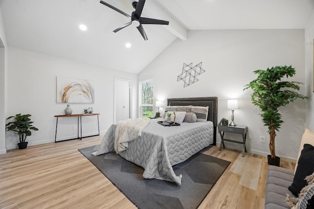 bedroom featuring light wood-type flooring, high vaulted ceiling, beamed ceiling, and ceiling fan