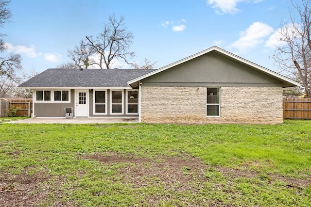 back of house featuring a patio and a lawn