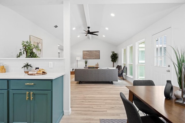 living room featuring ceiling fan, lofted ceiling with beams, and light wood-type flooring