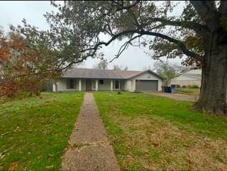 ranch-style house featuring a garage and a front yard