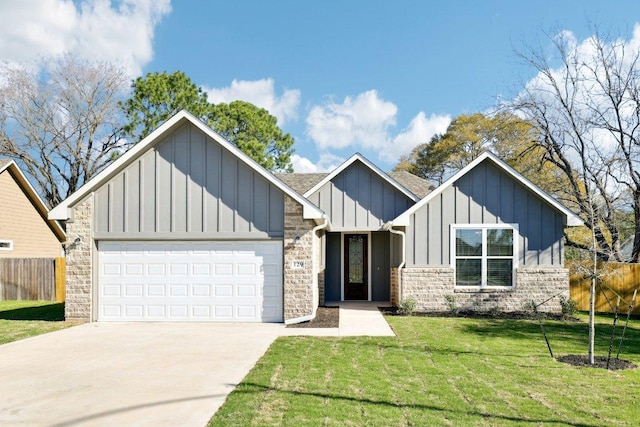 view of front of house with driveway, a front yard, fence, board and batten siding, and a garage