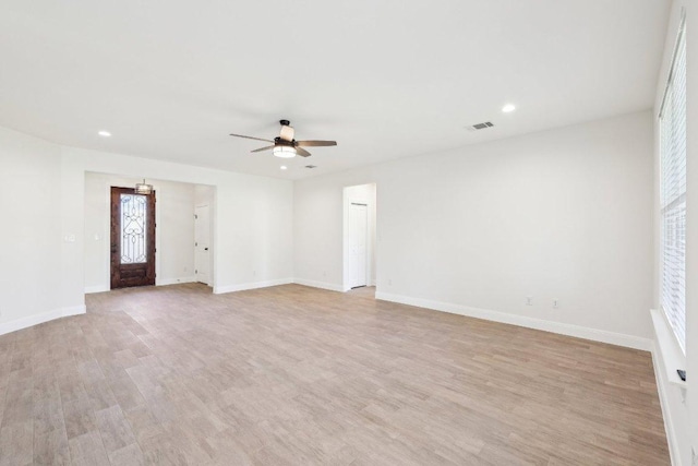 unfurnished living room featuring baseboards, light wood-style flooring, ceiling fan, and visible vents