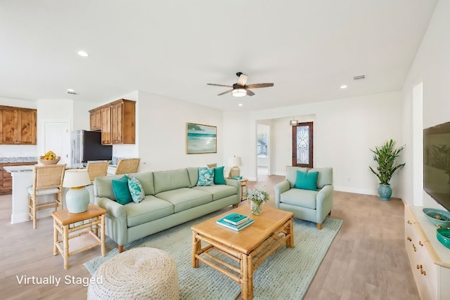 living room with a ceiling fan, light wood-type flooring, baseboards, visible vents, and recessed lighting