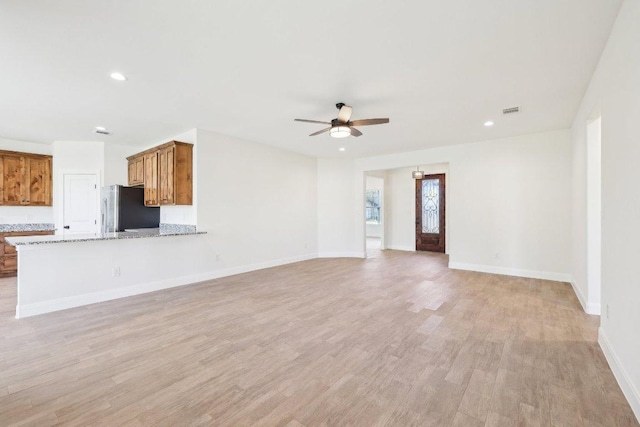 unfurnished living room with recessed lighting, baseboards, visible vents, light wood-style flooring, and ceiling fan