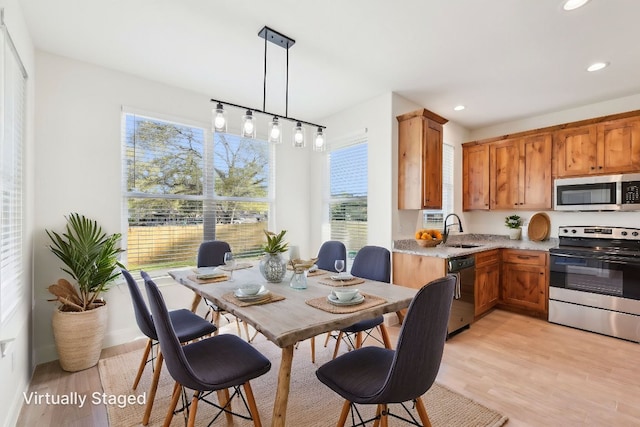 dining area featuring recessed lighting, light wood finished floors, and a wealth of natural light