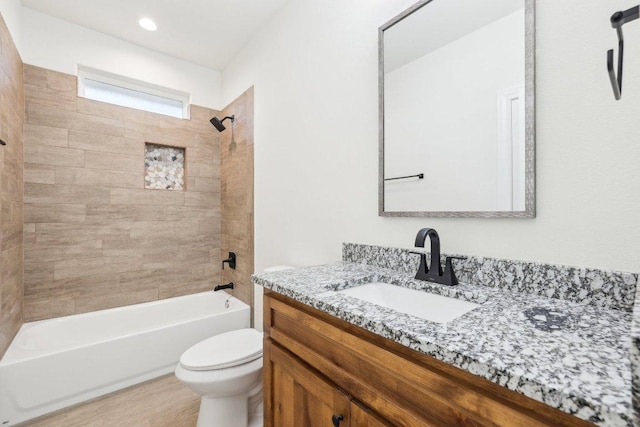 bathroom featuring  shower combination, toilet, vanity, and wood finished floors