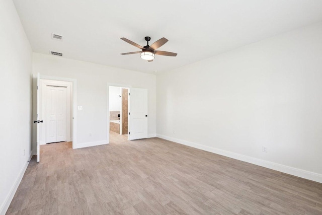 unfurnished bedroom featuring baseboards, visible vents, ceiling fan, and light wood-type flooring