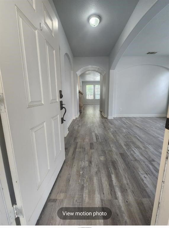 corridor with dark hardwood / wood-style floors