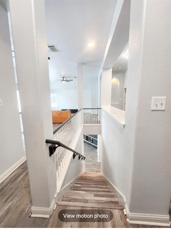 2500 National Park Blvd, Austin, TX 78747 - staircase with wood finished floors, a textured wall, and a ceiling fan