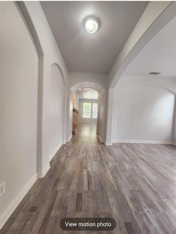 2500 National Park Blvd, Austin, TX 78747 - hallway with arched walkways and wood finished floors