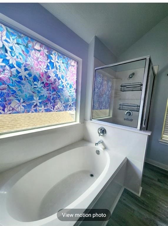 2500 National Park Blvd, Austin, TX 78747 - bathroom featuring a bath, wood finished floors, and lofted ceiling