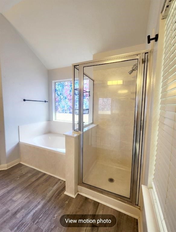 2500 National Park Blvd, Austin, TX 78747 - full bathroom featuring vaulted ceiling, a garden tub, wood finished floors, and a stall shower