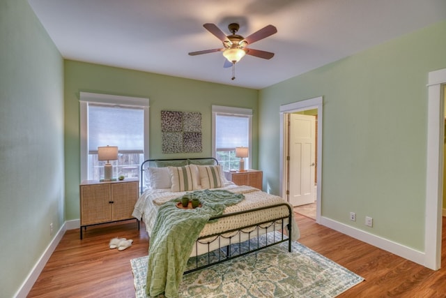 bedroom with ceiling fan and wood-type flooring