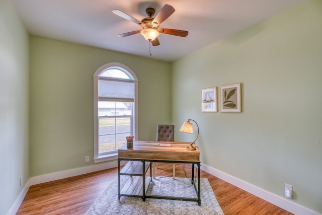 home office featuring ceiling fan and light hardwood / wood-style flooring