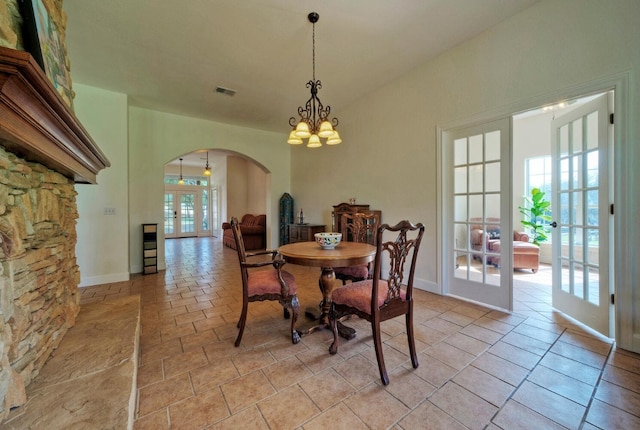 dining area with a notable chandelier and french doors