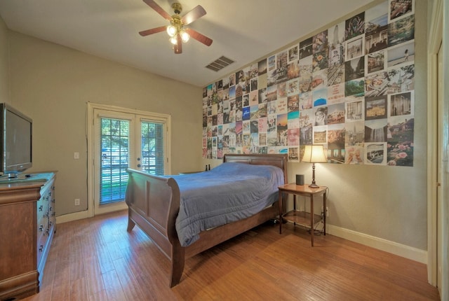 bedroom featuring hardwood / wood-style floors, french doors, ceiling fan, and access to outside