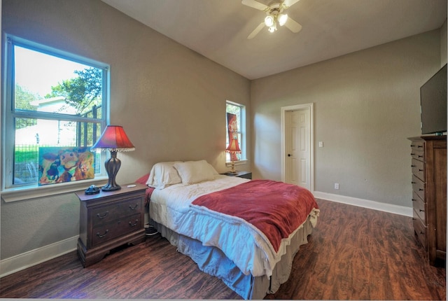 bedroom with dark hardwood / wood-style floors and ceiling fan