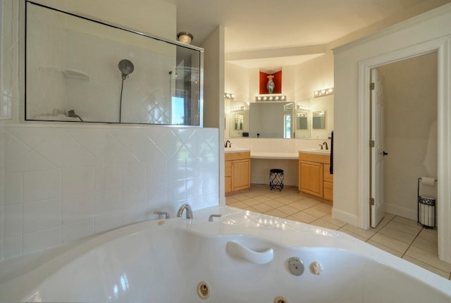 bathroom featuring tile patterned floors, vanity, and a bath