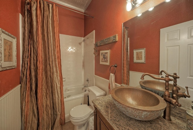 full bathroom featuring ornamental molding, shower / bath combination with curtain, vanity, and toilet