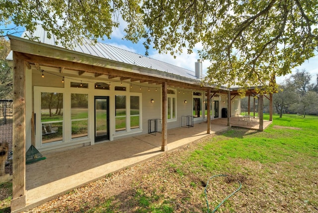 back of property featuring a yard and a patio area