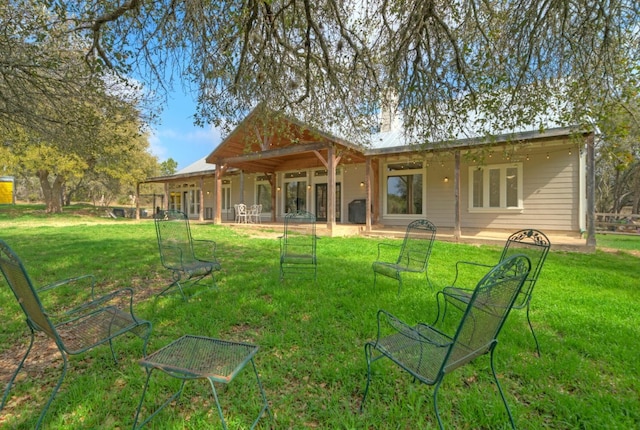 rear view of house with a lawn