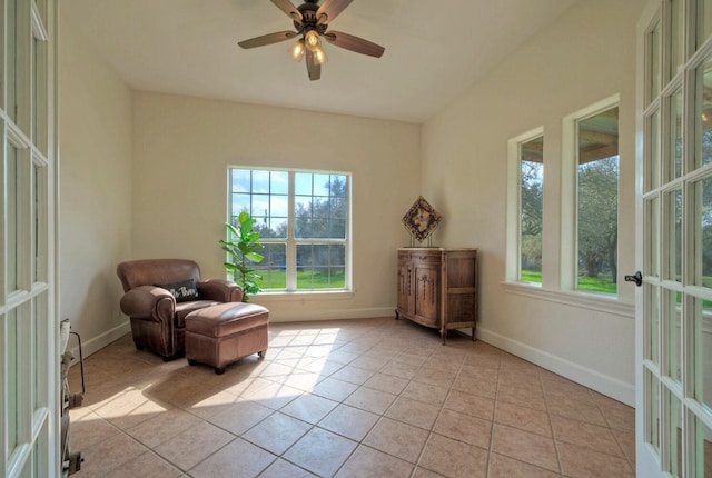 unfurnished room featuring french doors, light tile patterned flooring, and ceiling fan