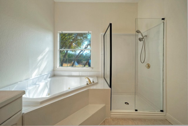 bathroom featuring tile patterned floors, separate shower and tub, and vanity