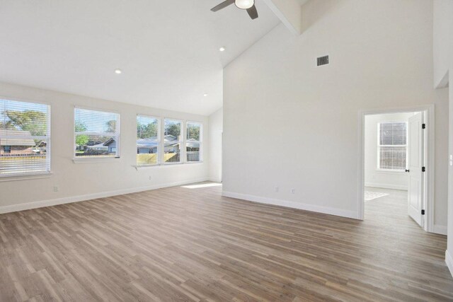 125 Callie St, Smithville, TX 78957 - empty room with high vaulted ceiling, visible vents, baseboards, wood finished floors, and a ceiling fan