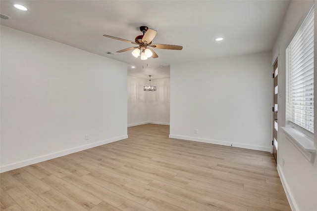 1402 Valleyridge Cir, Austin, TX 78704 - spare room featuring ceiling fan, a chandelier, recessed lighting, and light wood-style floors