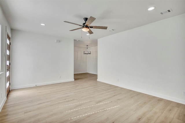 1402 Valleyridge Cir, Austin, TX 78704 - spare room featuring ceiling fan, recessed lighting, light wood-style flooring, and a chandelier
