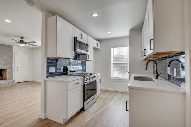 1402 Valleyridge Cir, Austin, TX 78704 - kitchen featuring appliances with stainless steel finishes, decorative backsplash, light countertops, light wood-style flooring, and recessed lighting