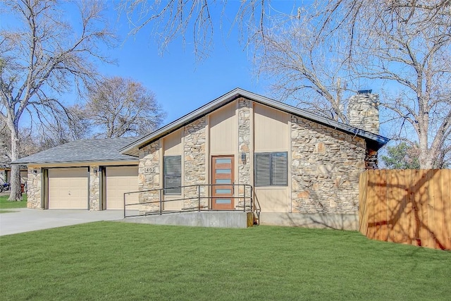 view of front of property featuring a garage, a front yard, driveway, and stone siding