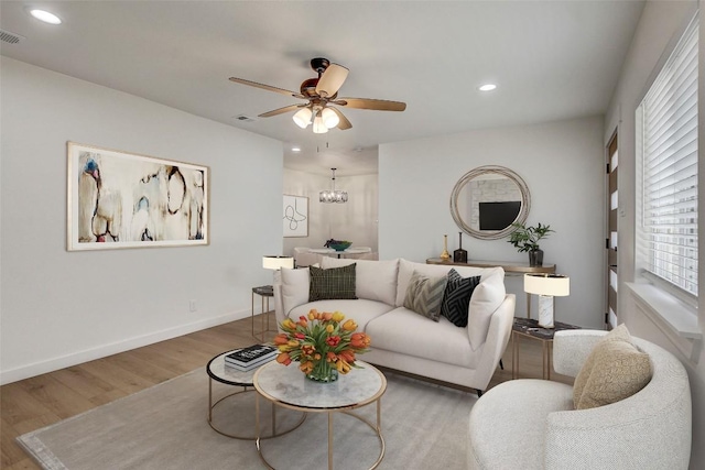 1402 Valleyridge Cir, Austin, TX 78704 - living area featuring wood finished floors, ceiling fan, recessed lighting, and a chandelier