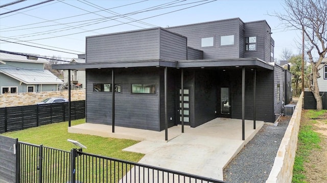 exterior space with a patio, a lawn, fence private yard, and central air condition unit