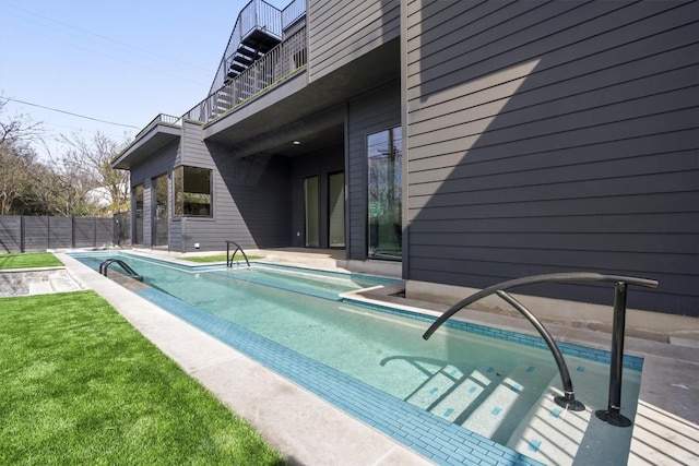 view of swimming pool featuring fence and a fenced in pool