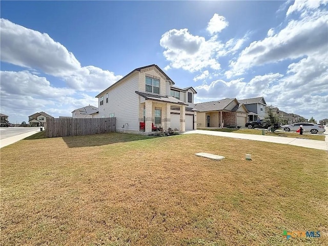 view of front of property with a front yard and a garage